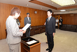 写真: 仙台市 奥山恵美子市長 (左) から辞令交付を受ける復興支援室 加藤英夫課長補佐＝仙台市役所 (宮城県仙台市)